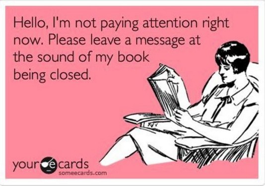 The text 'Hello, I'm not paying attention right now. Please leave a message at the sound of my book being closed.' next to line art of a woman reading a book.